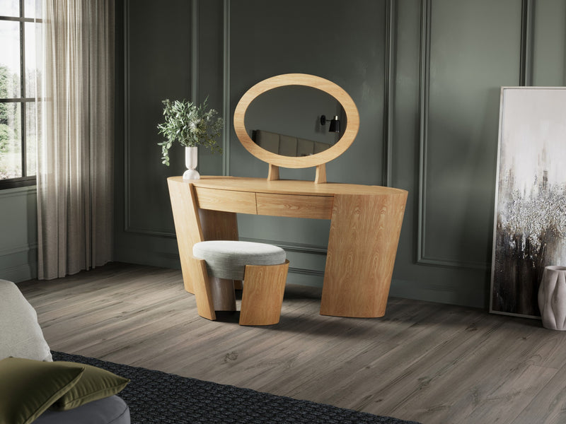 A light-colored wooden vanity with a round mirror and a stool
